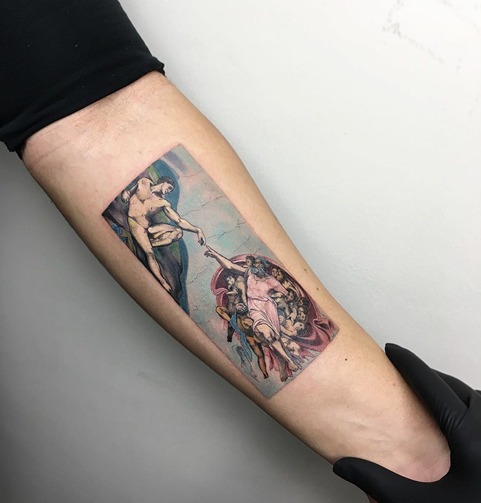Classical art-inspired tattoo on an arm, depicting a famous Renaissance painting.