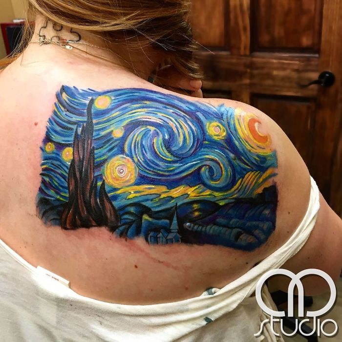Classical art-inspired tattoo of Van Gogh's "Starry Night" on a shoulder.
