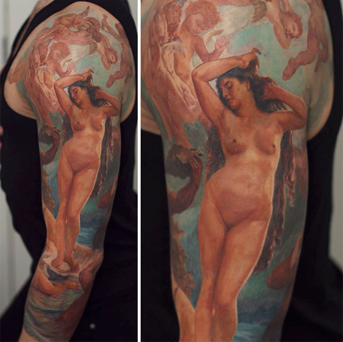 Tattoo depicting classical art-inspired design featuring a n**e figure and cherubs on an upper arm.