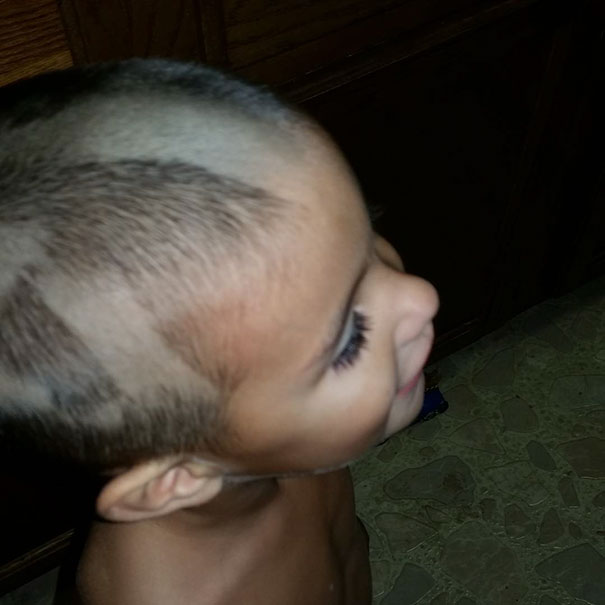 Child with uneven self-haircut, hair partially shaved, showcasing a regretted haircut decision.