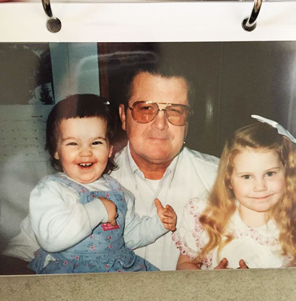Child with self-cut hair smiling next to an adult and another child with long hair.