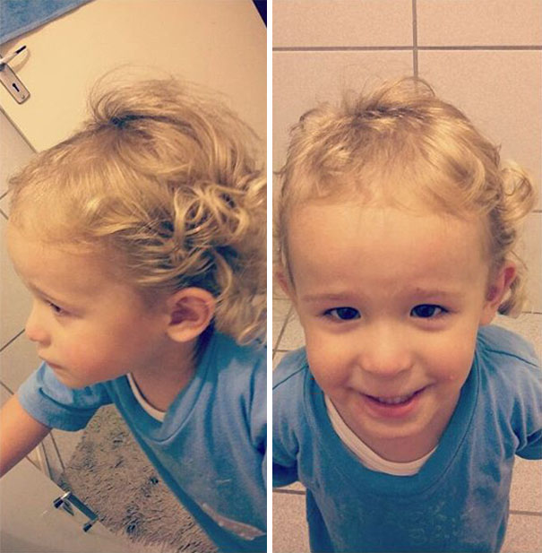 Toddler with self-cut curly hair, wearing a blue shirt and smiling, showcasing kids' haircut adventures.