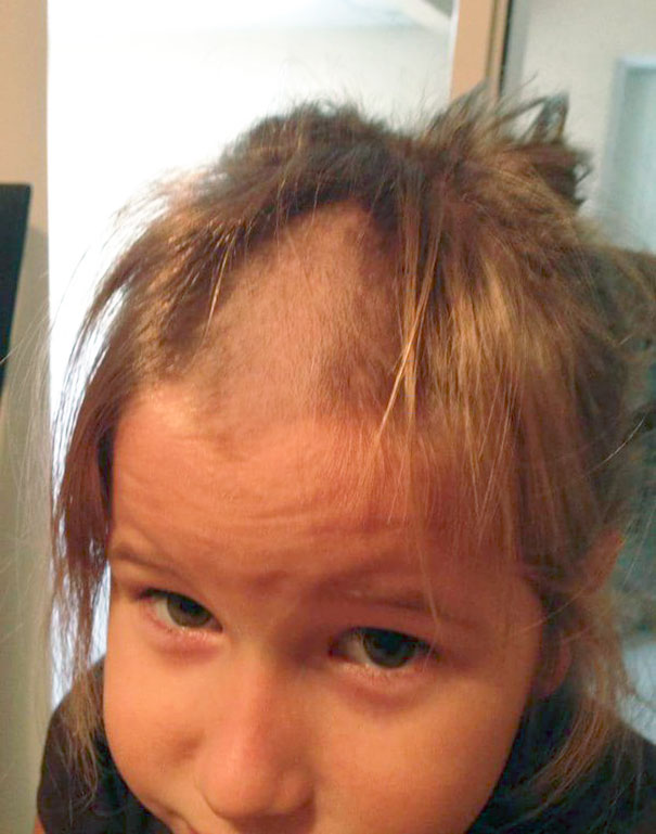 Child with a self-cut hairstyle looking regretful, highlighting kids experimenting with their own haircuts.