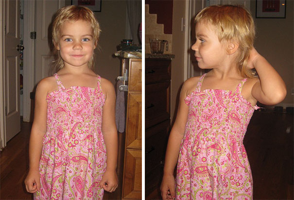 Young child proudly shows off a self-styled haircut, wearing a pink dress.