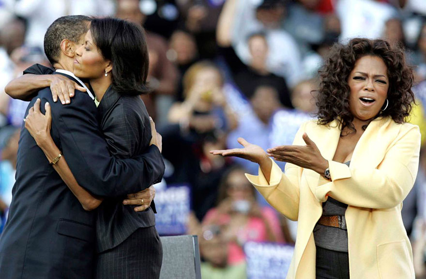 Michelle hugging Barack next to Oprah