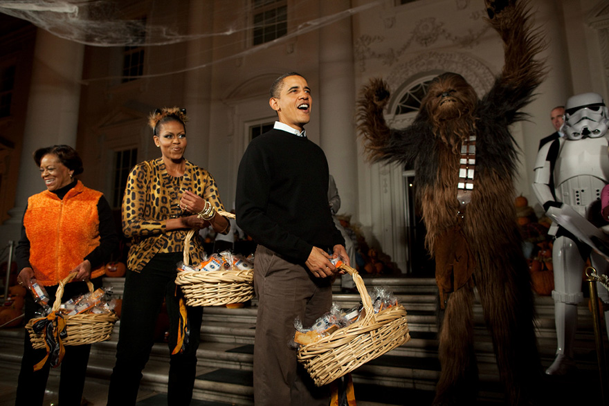 Obama couple holding baskets with candies during Halloween 