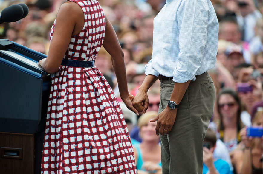 Barack holding Michelles' hand