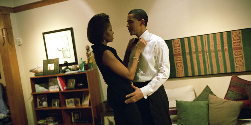 Michelle adjusting Baracks' bow-tie 
