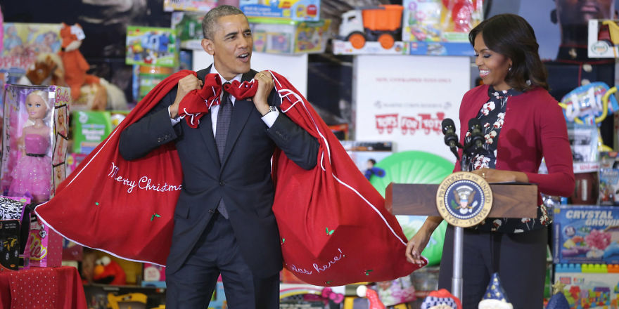 Barack carrying two bags filled with toys 