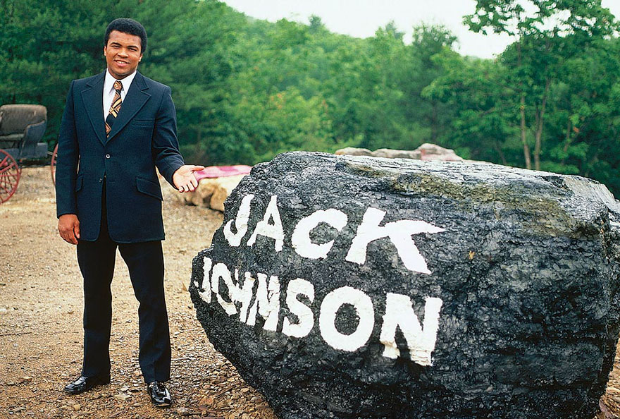 Muhammad Ali Is Photographed Next To A Boulder Paying Tribute To Legendary Boxer Jack Johnson At His Deer Lake, Pa Training Camp In July Of 1974