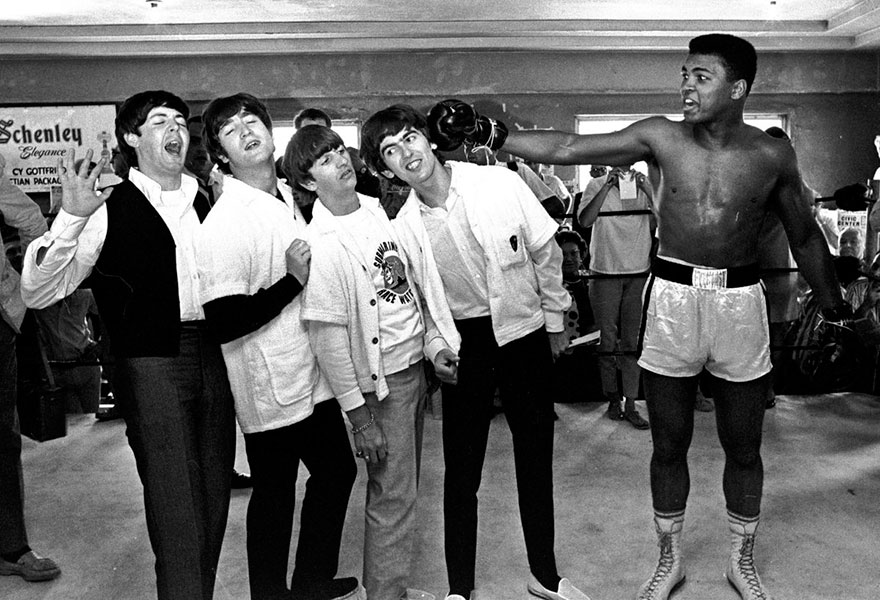 In This Feb. 18, 1964 The Beatles, From Left, Paul Mccartney, John Lennon, Ringo Starr And George Harrison, Take A Fake Blow From Cassius Clay, Who Later Changed His Name To Muhammad Ali, While Visiting The Heavyweight Contender At His Training Camp In Miami Beach, Fla