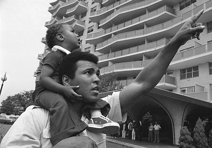 Muhammad Ali Carries His Son, Muhammad Ali, Jr., On His Shoulders, Aug. 24, 1974, As He Points Toward The Building In Cherry Hill, N.J.