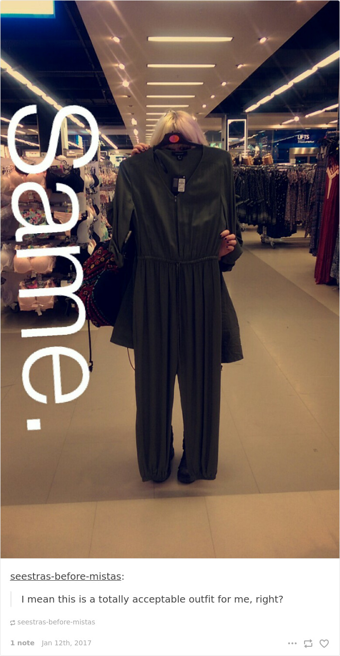 Short person humor: a woman humorously hides behind a long dress in a clothing store.