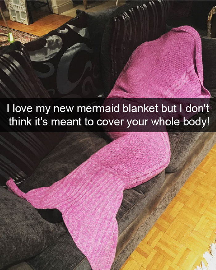 Person fully covered by a pink mermaid blanket on a couch, illustrating short people problems humorously.