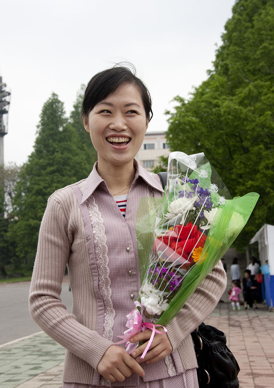 Woman With A Bunch Of Flowers In Pyongyang, North Korea