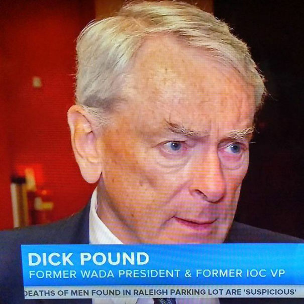 An older man with white hair in a news interview, highlighting funny names.