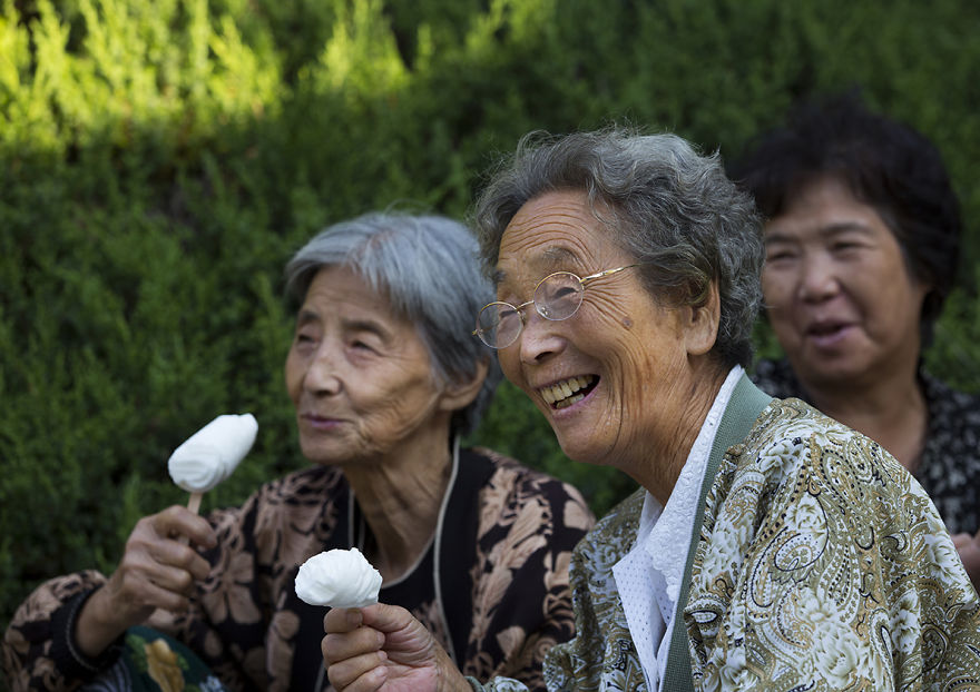 North Korean Eating Ice Cream In A Park On National Day, Pyongyang, North Korea