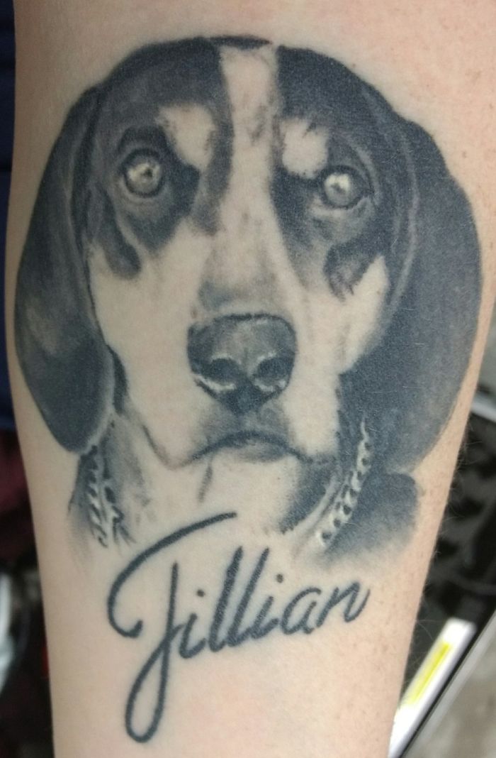 Realistic dog tattoo with the name "Jillian" beneath, showcasing a unique pet-inspired design.