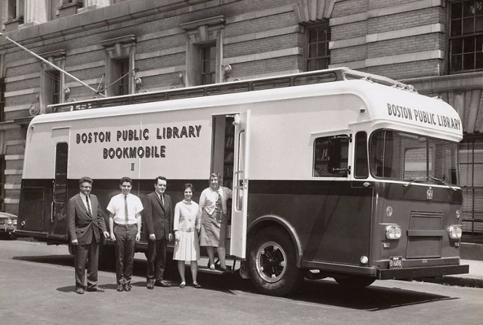 Vintage Boston Public Library bookmobile with staff standing outside, showcasing libraries-on-wheels before Amazon era.