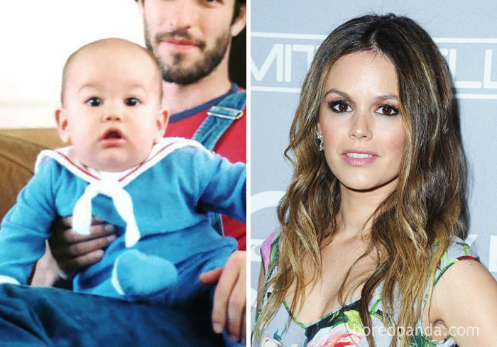 Rare celebrity childhood photo of a baby in blue outfit next to an adult woman with long wavy hair at an event.