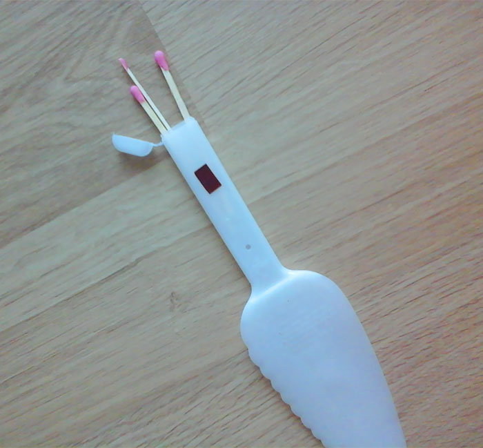 cake knife with a storage in the grip for matches