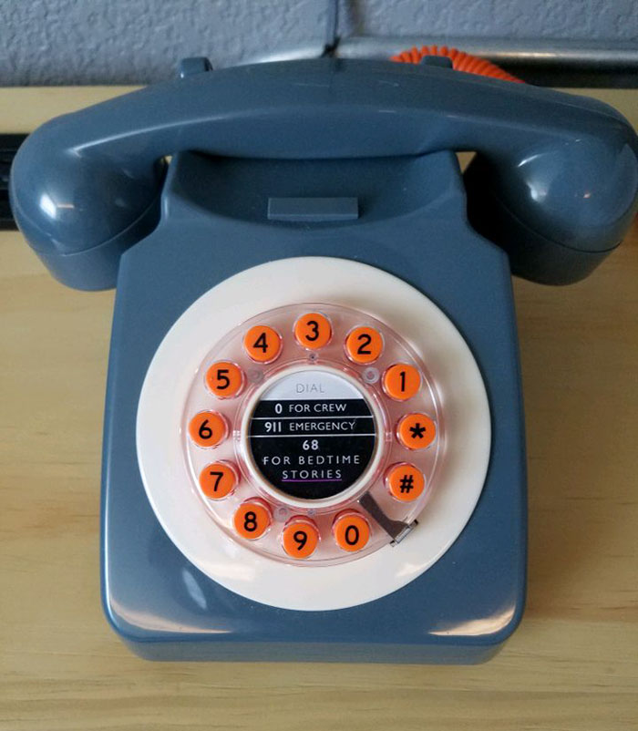 a blue retro phone with orange buttons