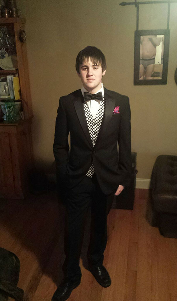 Naked man taking photo of a man wearing suit 