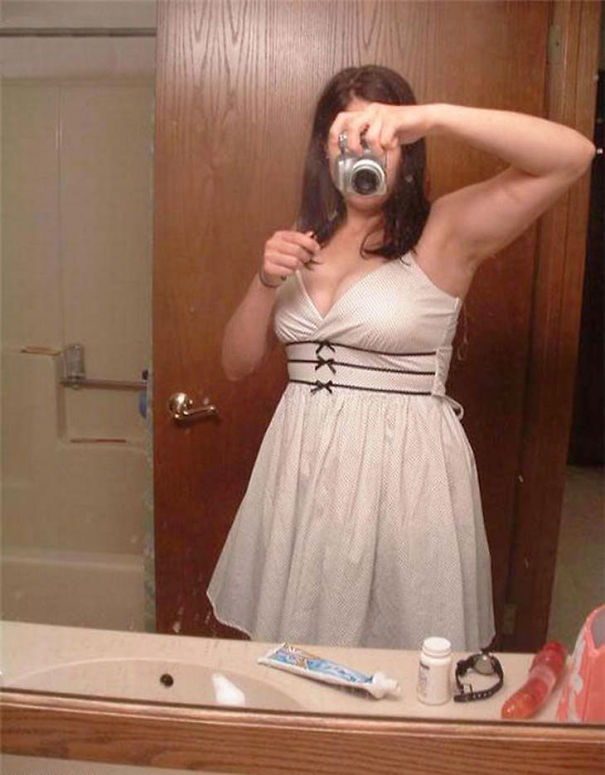 Woman taking mirror selfie 