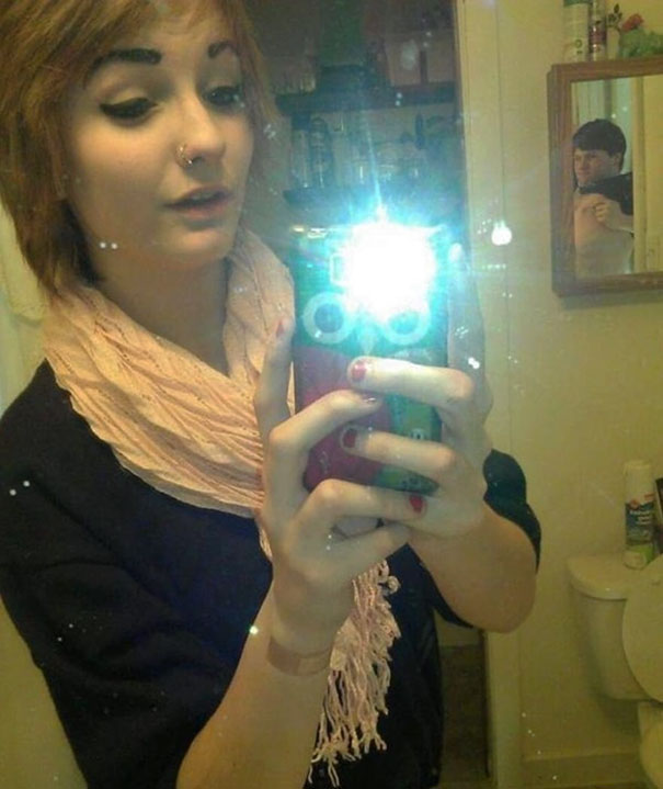 Woman taking mirror selfie 