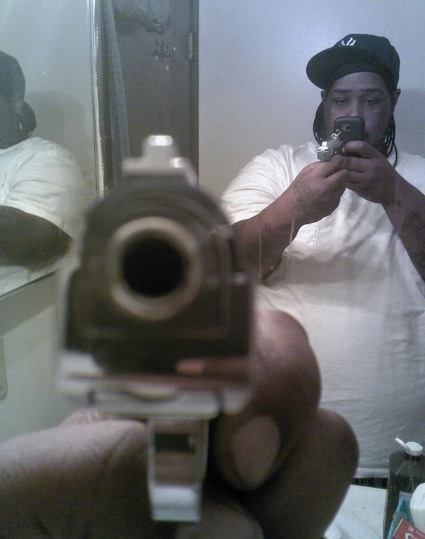 Man taking selfie with the gun