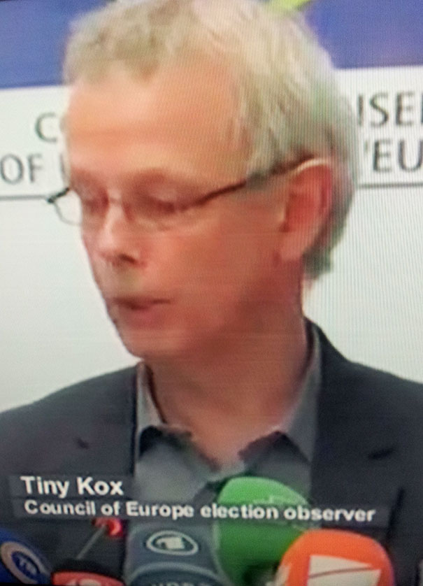 Election observer speaking to media, labeled with a funny name.