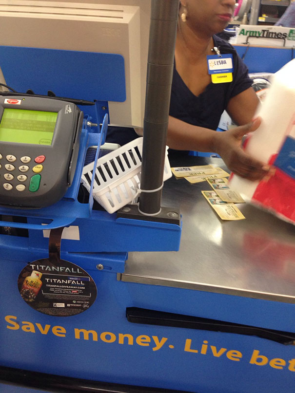 Cashier wearing a name badge with a humorous name at a checkout counter, aligning with funny names theme.