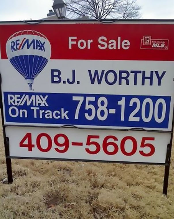 Realtor sign with funny name, B.J. Worthy, for a property sale, featuring RE/MAX branding and contact numbers.
