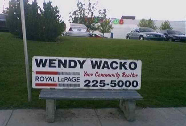 Bench advertisement for realtor Wendy Wacko, with a humorous name, located in a grassy area with parked cars.