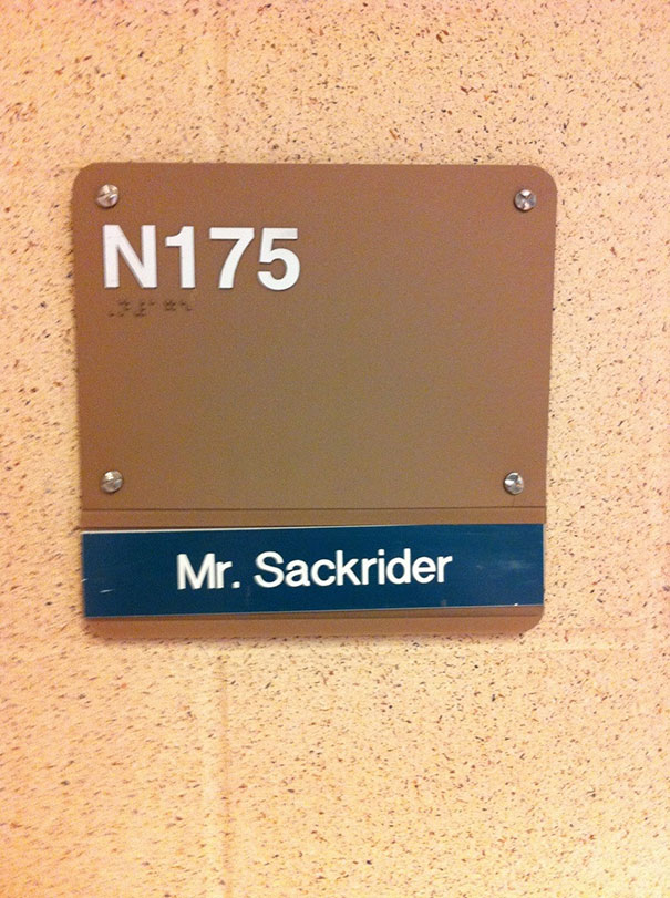 Sign with a funny name, "Mr. Sackrider," on a beige wall, highlighting humorous names.