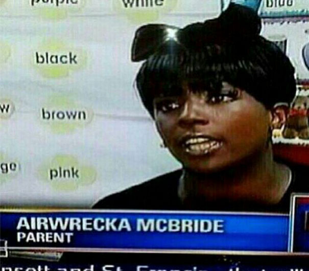 Woman featured on TV segment with a humorous name tag display.
