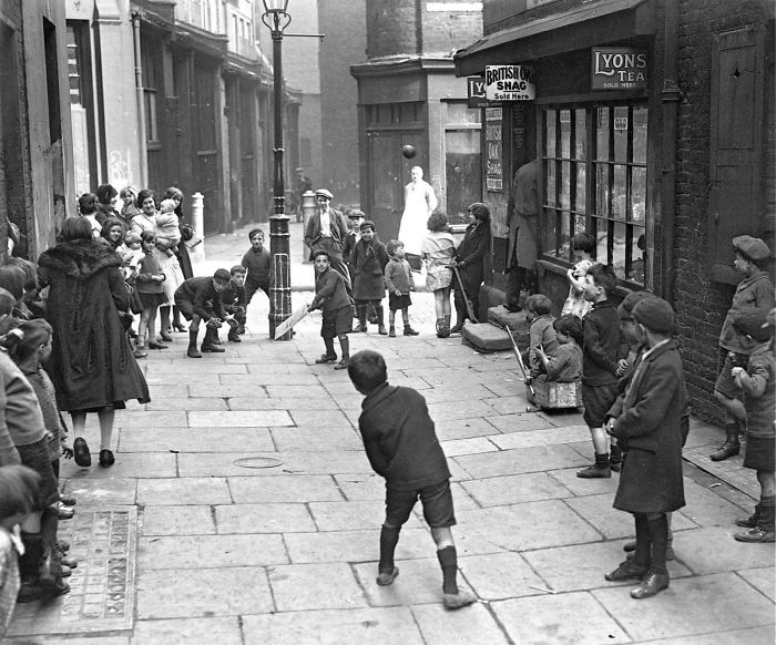 Children Playing Cricket In A London Street, With The Wicket Drawn On A Lamppost, 1930