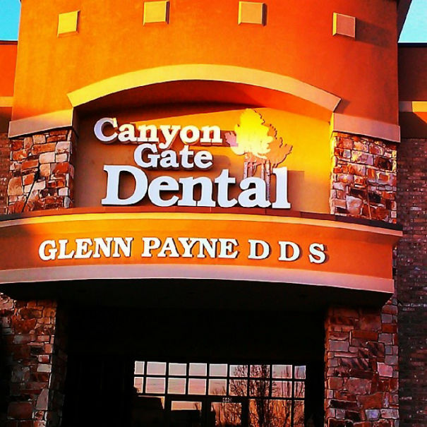 "Canyon Gate Dental sign with a humorous name, Glenn Payne DDS, on a brick building facade."
