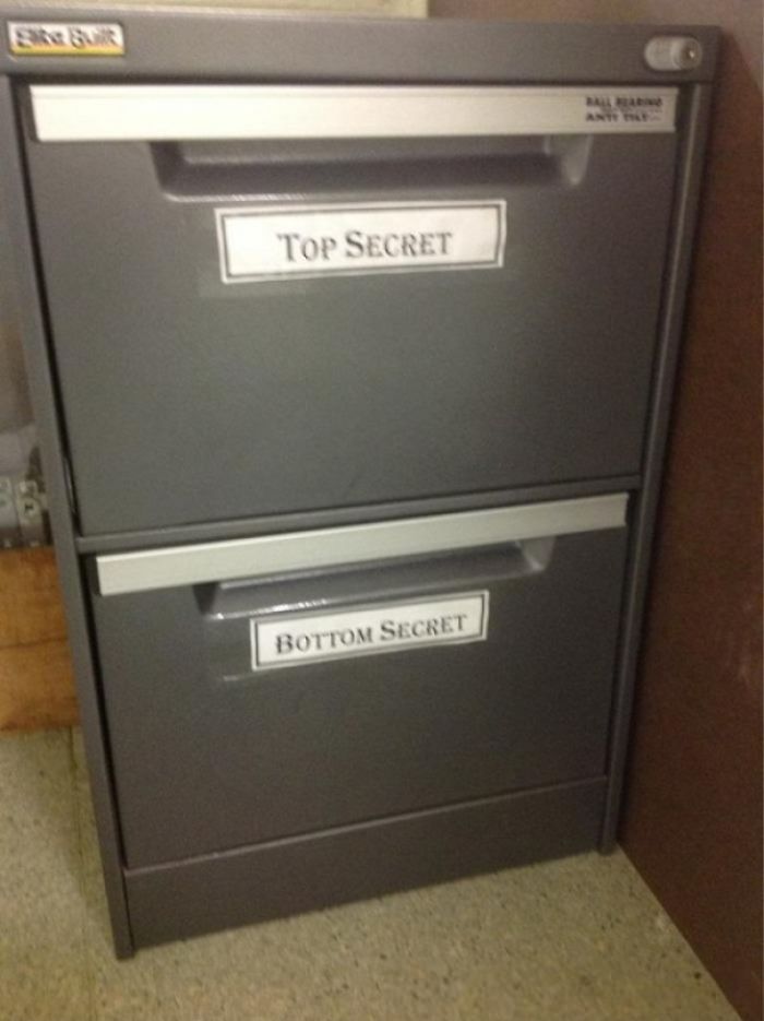 Filing cabinet labeled with humorous "Top Secret" and "Bottom Secret" signs, showcasing dad jokes.