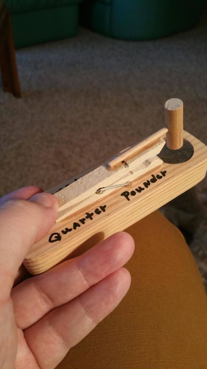 Dad joke creation: a wooden "quarter pounder" tool held in hand, showcasing humorous craftsmanship.