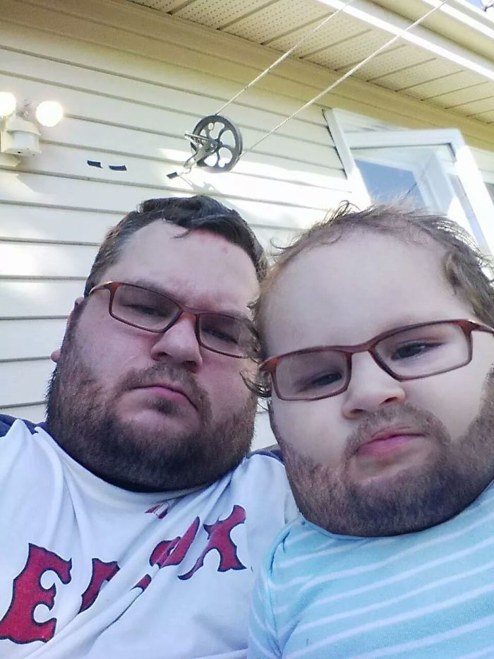 Dad and child with matching glasses and funny Photoshop beards, showcasing dad jokes at another level.