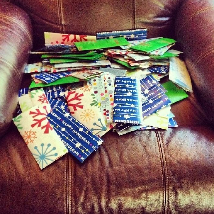 Dad joke taken to another level: a chair covered in gift cards with humorous holiday designs.