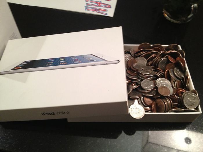 Dad jokes elevated: iPad box filled with assorted coins as a humorous surprise.