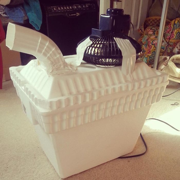 Homemade air conditioner with a fan and cooler, showcasing dad humor creativity in a practical joke.