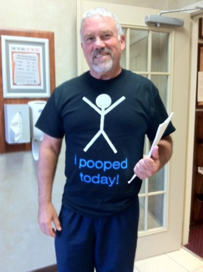 Man wearing a humorous shirt that reads "I pooped today!" as a dad joke.
