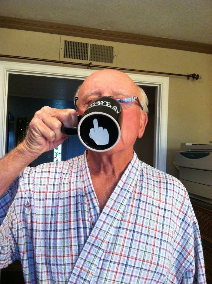 Dad in a plaid robe drinking from a mug with a cheeky design, showcasing dad jokes humor.