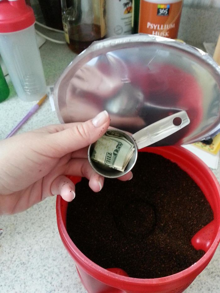 A dad joke captured: money hidden inside a coffee container's scoop.