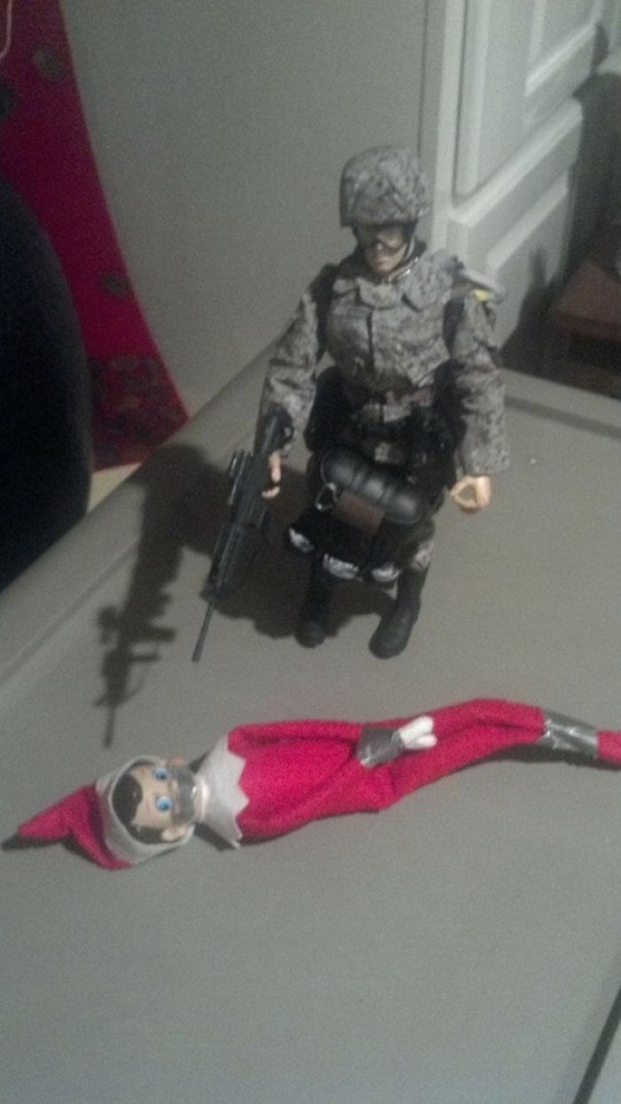 Toy soldier with a gun guarding a duct-taped elf doll; showcasing creative dad jokes.