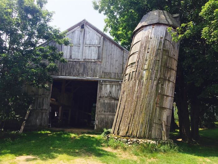 Old barn with a leaning silo, showcasing a classic example of dad-level humor with exaggerated tilt.