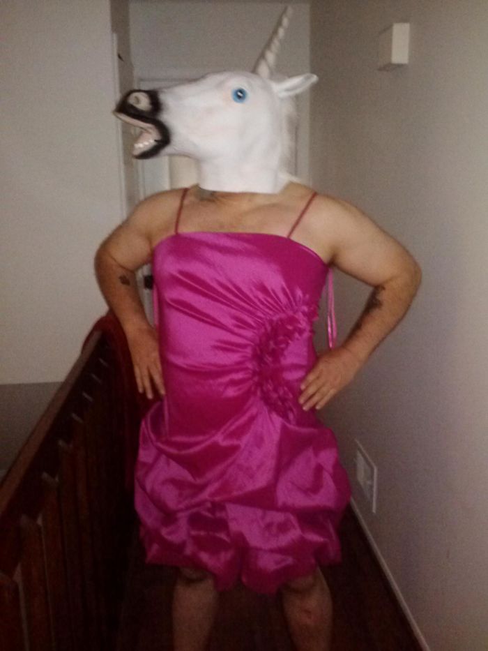Dad wearing a unicorn mask and pink dress, showcasing a humorous take on jokes.